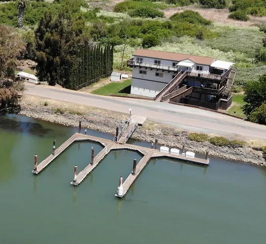 an aerial view of a house with a yard pool outdoor seating and yard