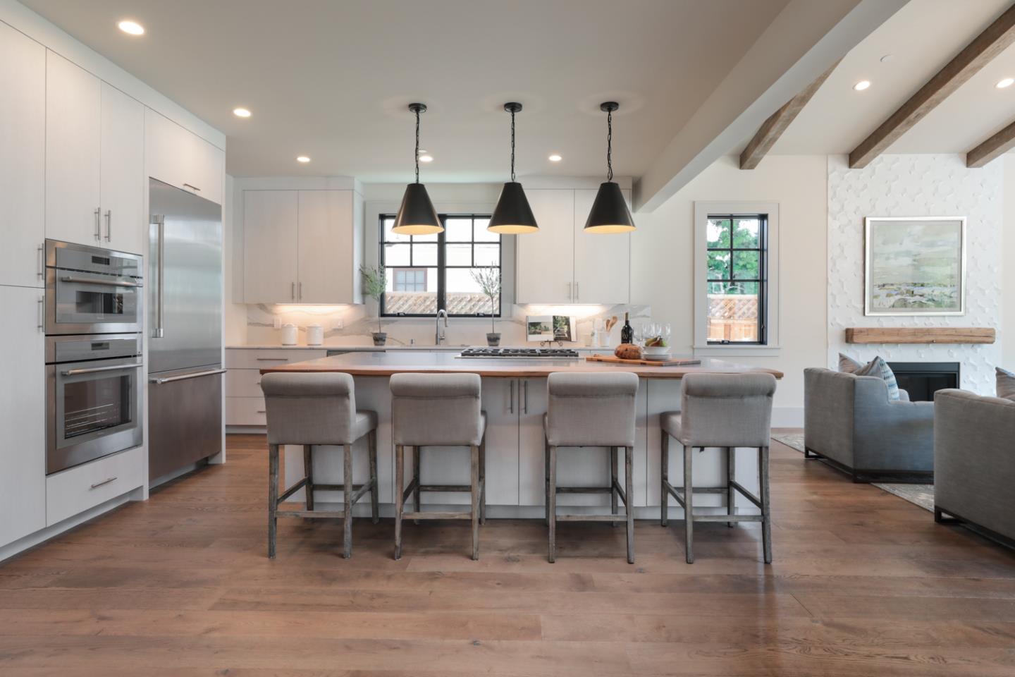 28 Bloomfield Road Burlingame, CA 94010 - Photo 8 of 27 a kitchen with stainless steel appliances kitchen island granite countertop a table chairs sink and cabinets