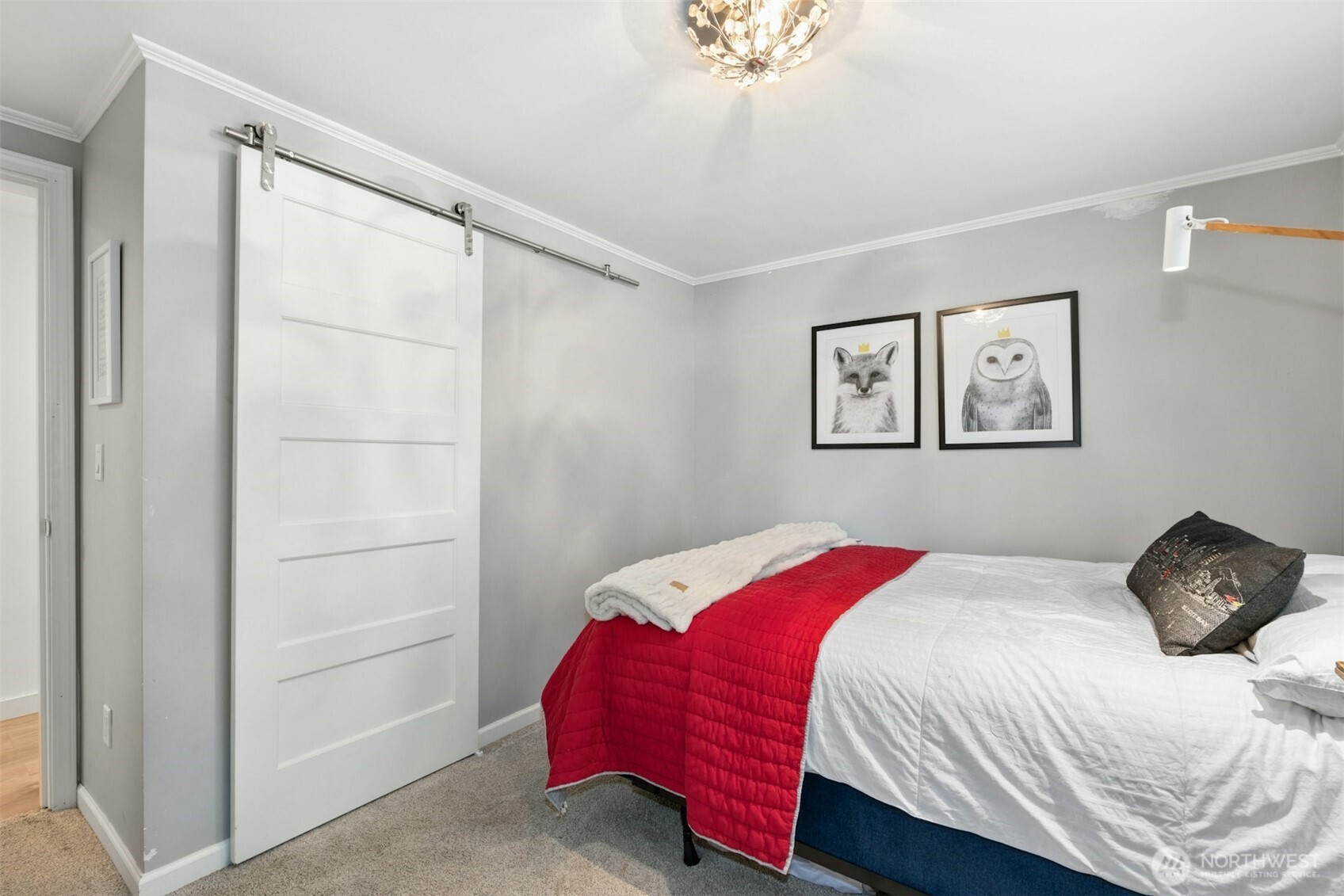 23307 49th Avenue Southeast Bothell, WA 98021 - Photo 19 of 37 a bedroom with a bed and a chandelier