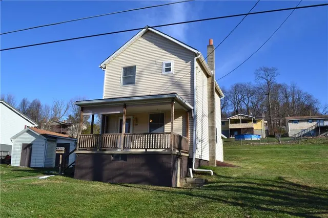 a front view of house with yard and green space