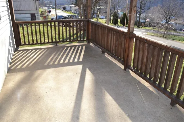 a view of a balcony with wooden floor