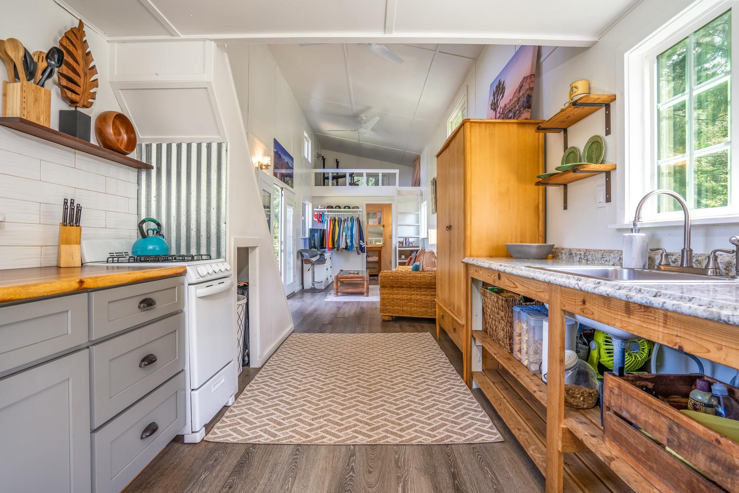 1740 Kokomo Road, Unit B Haiku, HI 96708 - Photo 15 of 29 a kitchen with stainless steel appliances granite countertop a lot of counter space and wooden floors