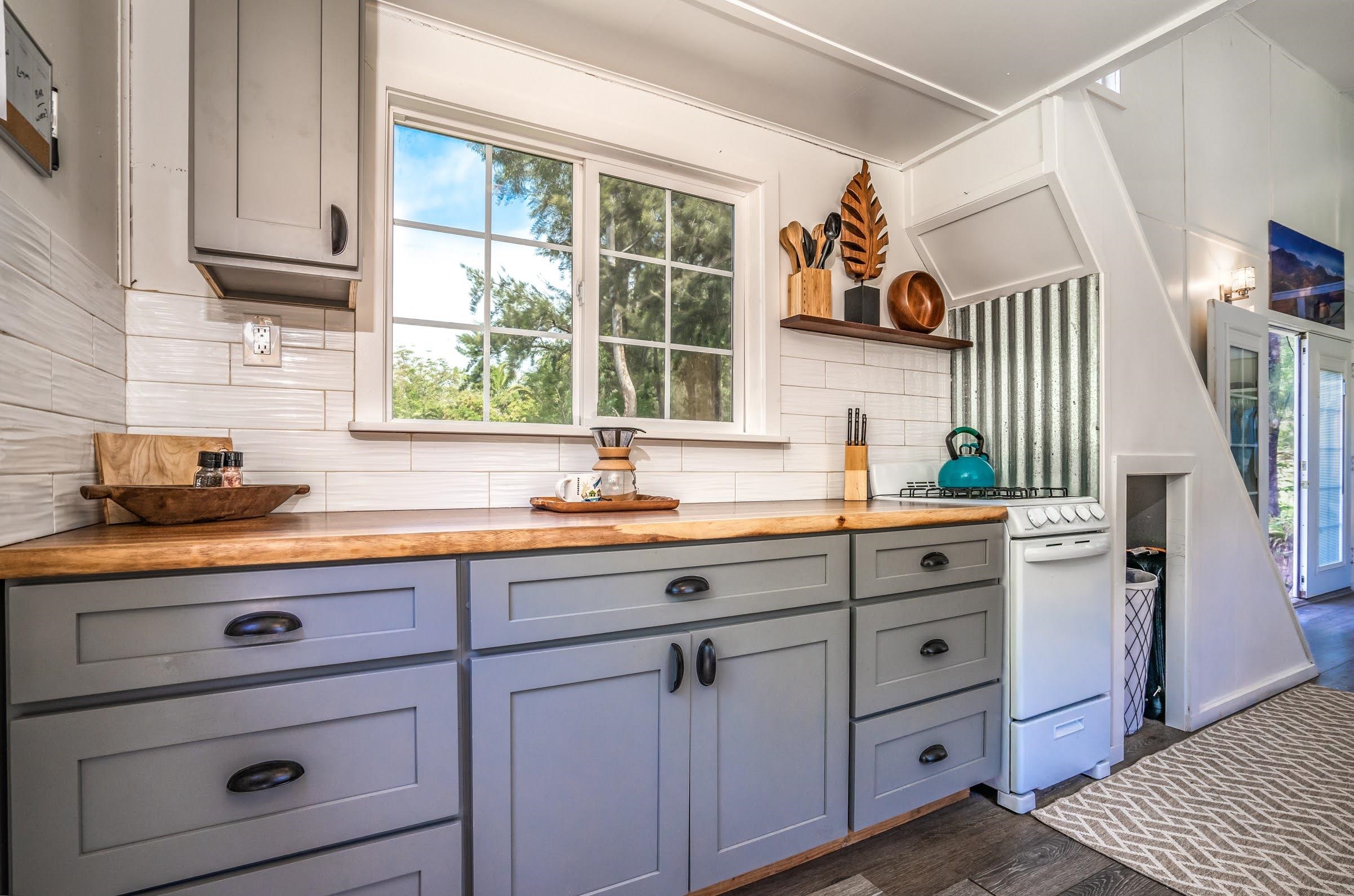 1740 Kokomo Road, Unit B Haiku, HI 96708 - Photo 16 of 29 a kitchen with cabinets appliances and a window