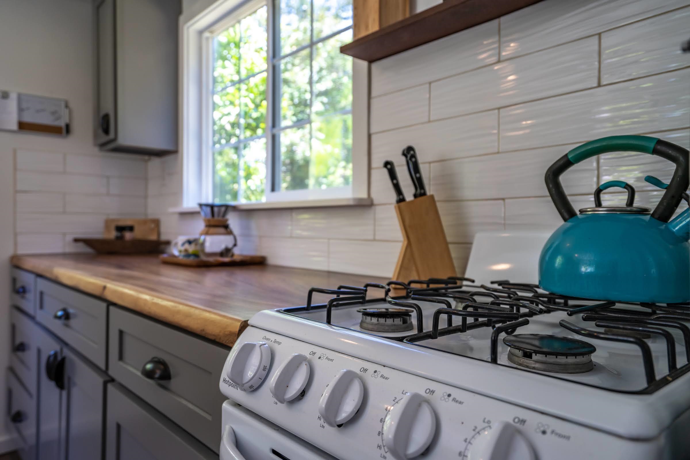 1740 Kokomo Road, Unit B Haiku, HI 96708 - Photo 17 of 29 a kitchen with a stove and a sink