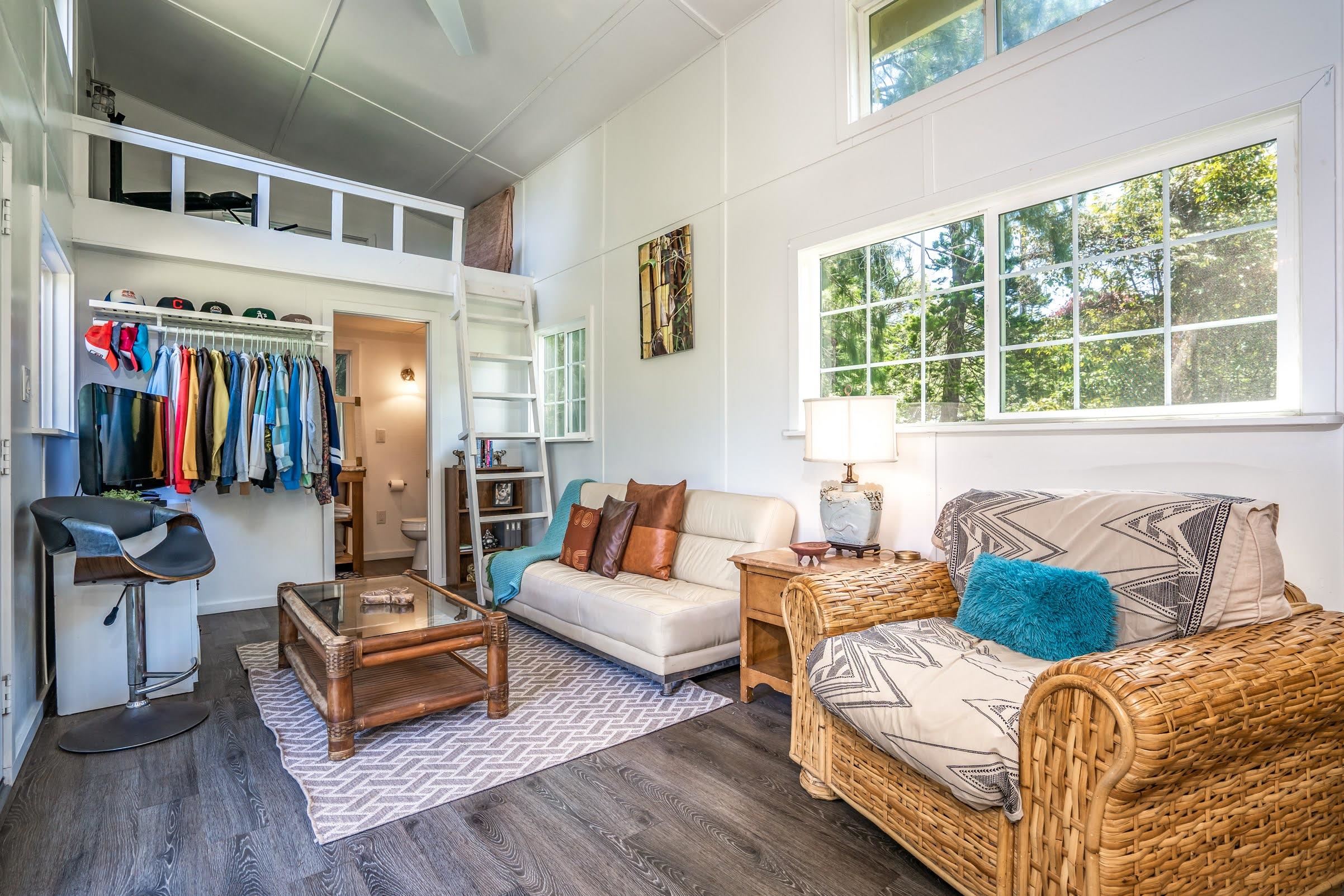 1740 Kokomo Road, Unit B Haiku, HI 96708 - Photo 18 of 29 a living room with furniture a flat screen tv and a large window