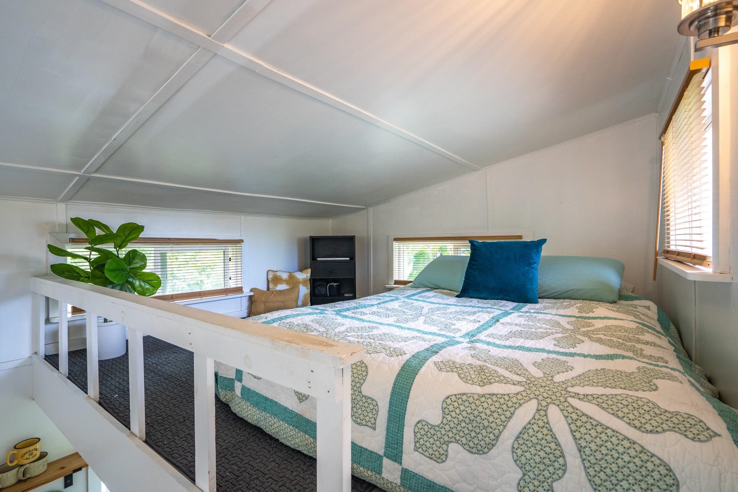 1740 Kokomo Road, Unit B Haiku, HI 96708 - Photo 23 of 29 a bed sitting in a bedroom next to a window