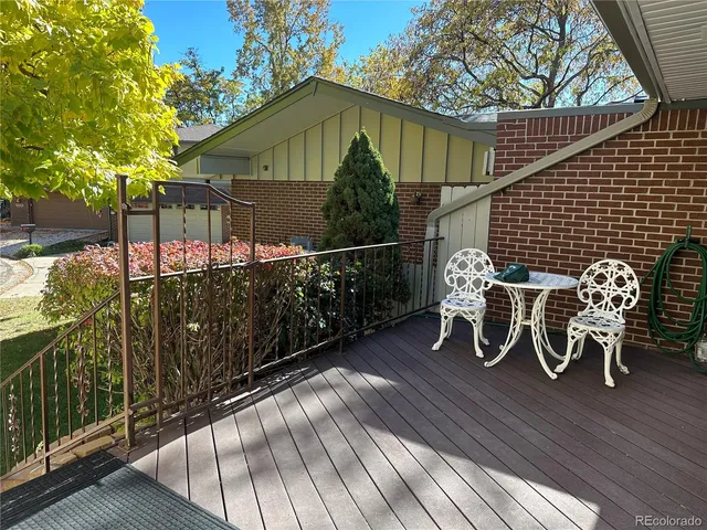 a view of a chairs and table on the wooden deck