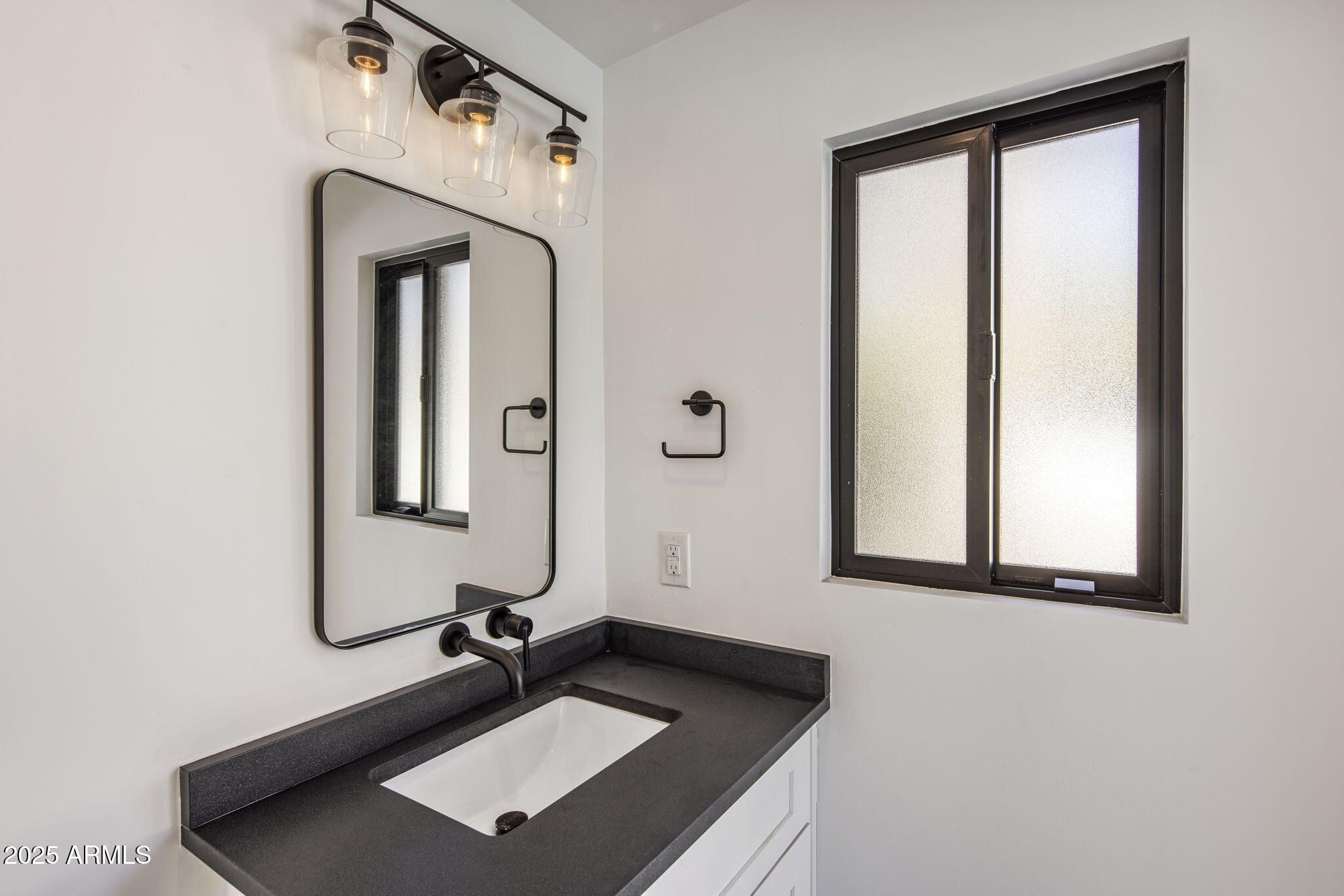 525 West Berridge Lane Phoenix, AZ 85013 - Photo 51 of 67 a bathroom with a sink a mirror and a window