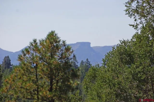 a view of a building in middle of the green field