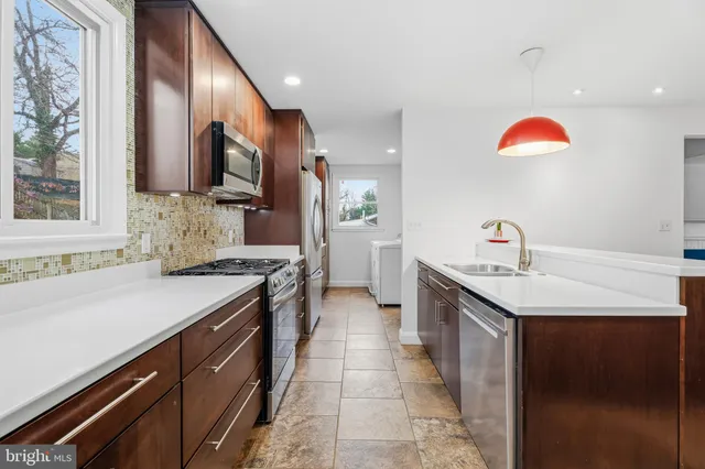 a kitchen with a sink stove and cabinets
