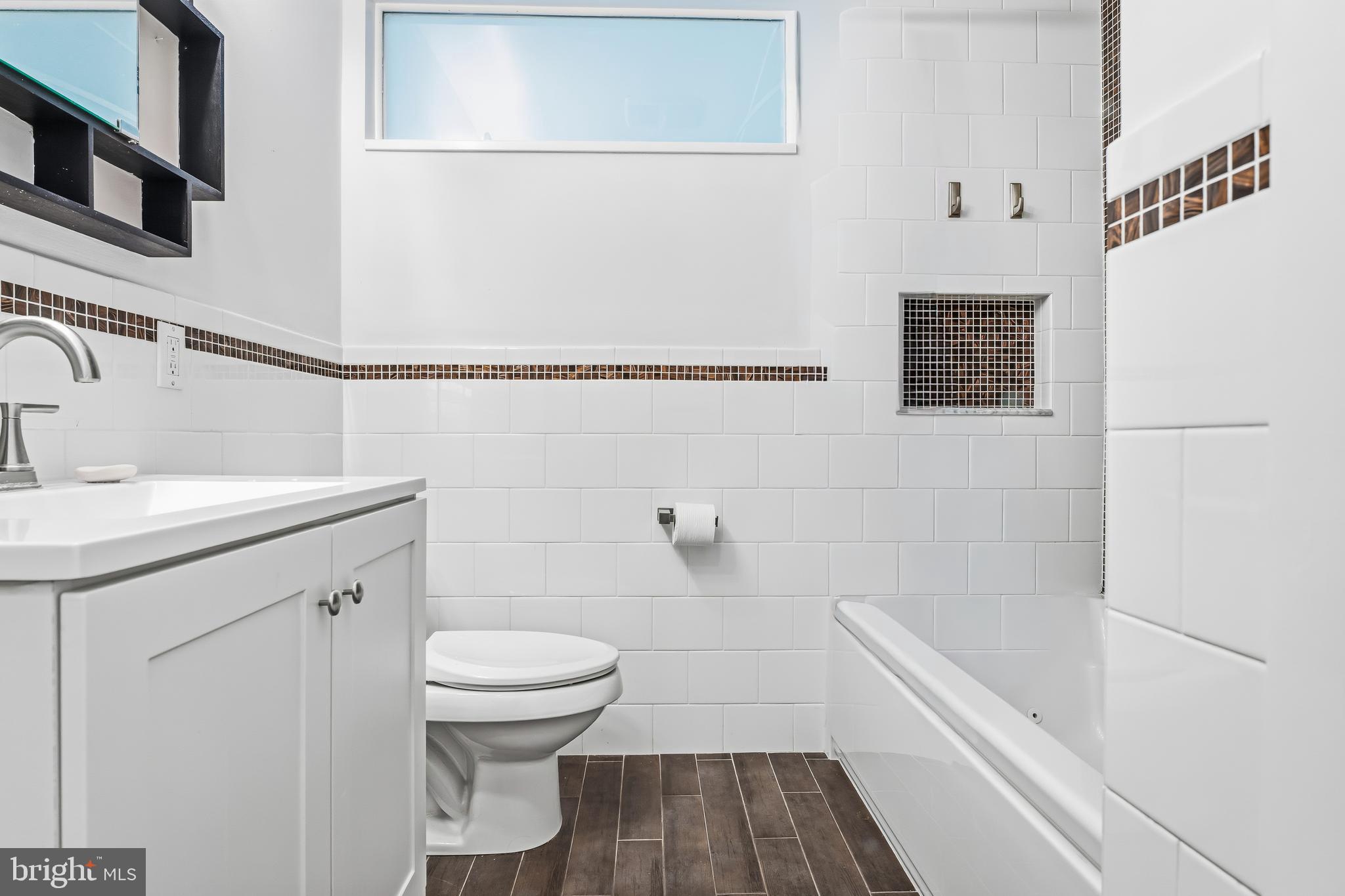 60 Belmore Road Lutherville-Timonium, MD 21093 - Photo 19 of 28 a bathroom with a sink a toilet and shower
