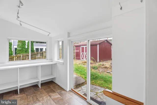 a backyard of a house with table and chairs