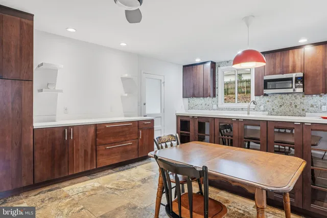 a kitchen with a table and chairs in it