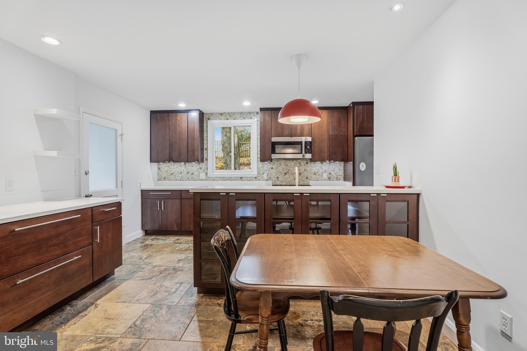 60 Belmore Road Lutherville-Timonium, MD 21093 - Photo 10 of 28 a kitchen with a table chairs sink and cabinets