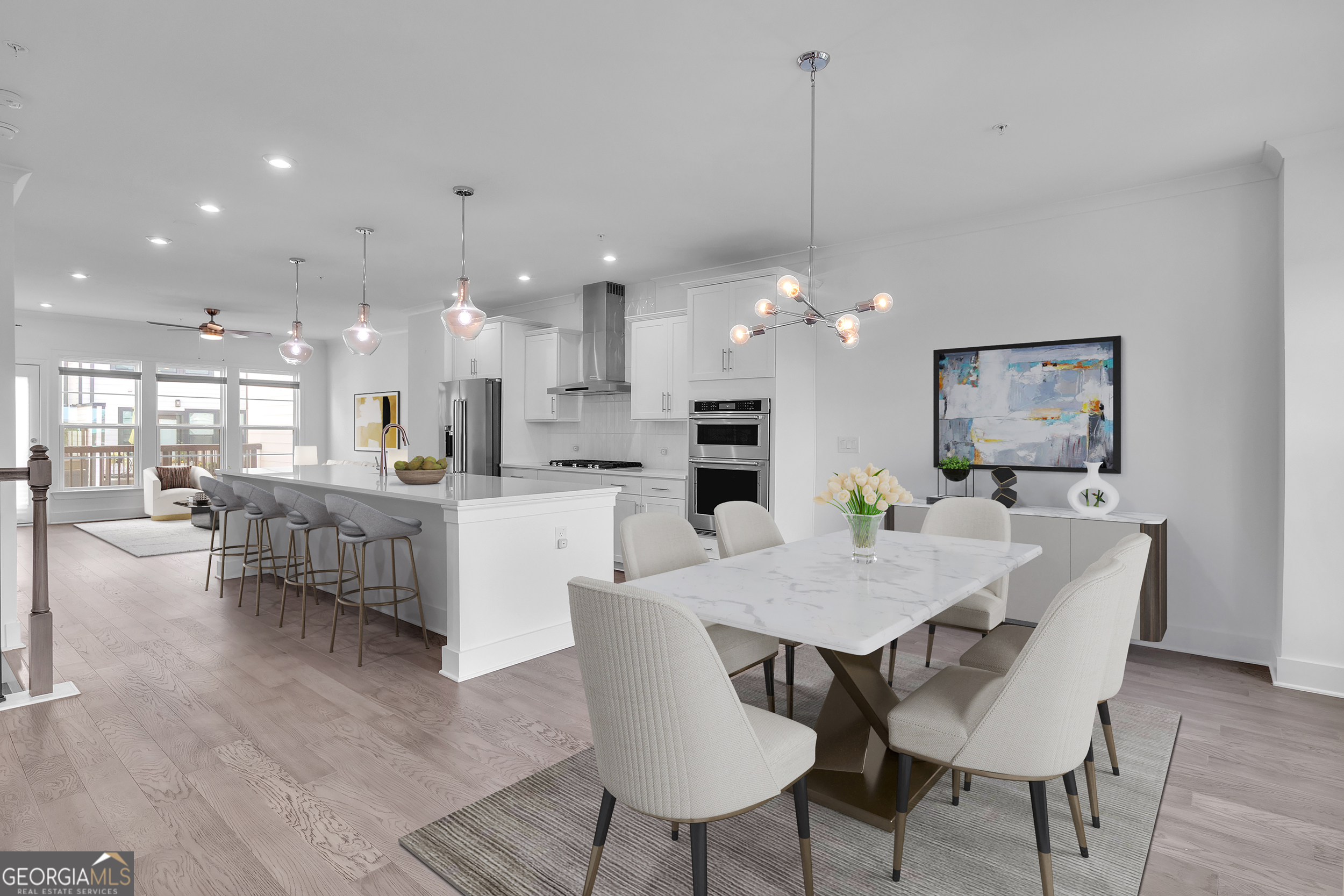 a view of a dining room and livingroom with furniture wooden floor a rug a chandelier