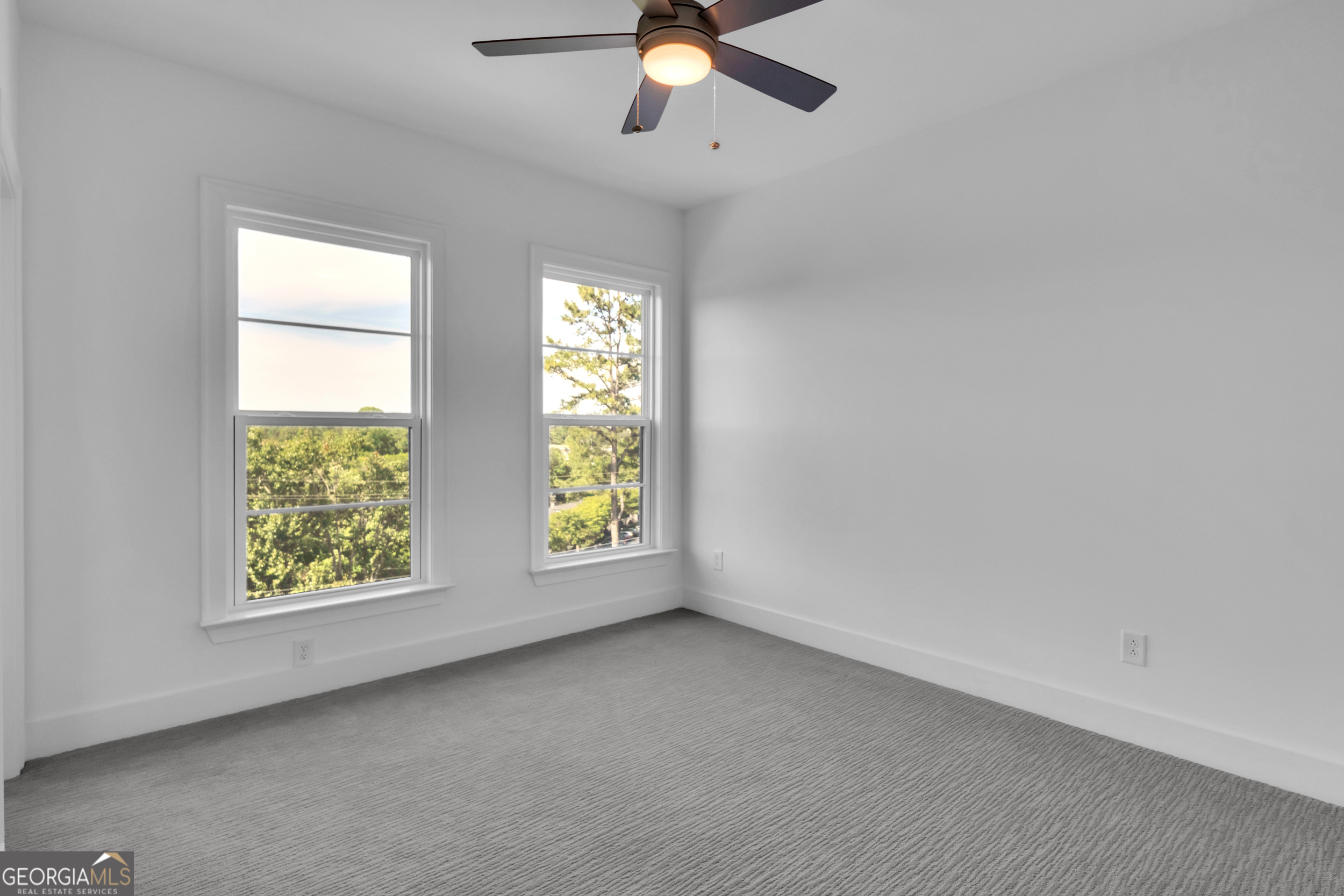 545 Whitlox Road Northwest Atlanta, GA 30309 - Photo 14 of 65 an empty room with window chandelier fan and windows
