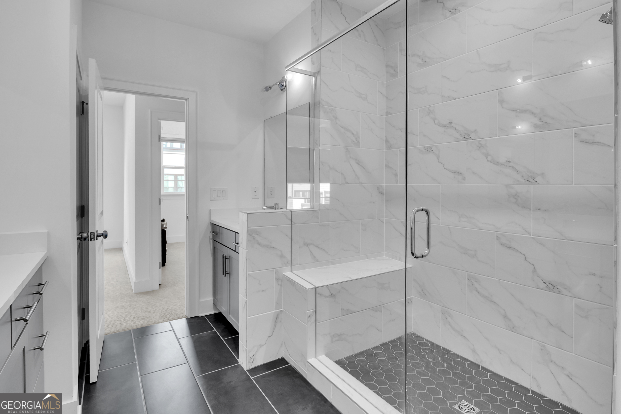 545 Whitlox Road Northwest Atlanta, GA 30309 - Photo 23 of 65 a bathroom with a glass shower door