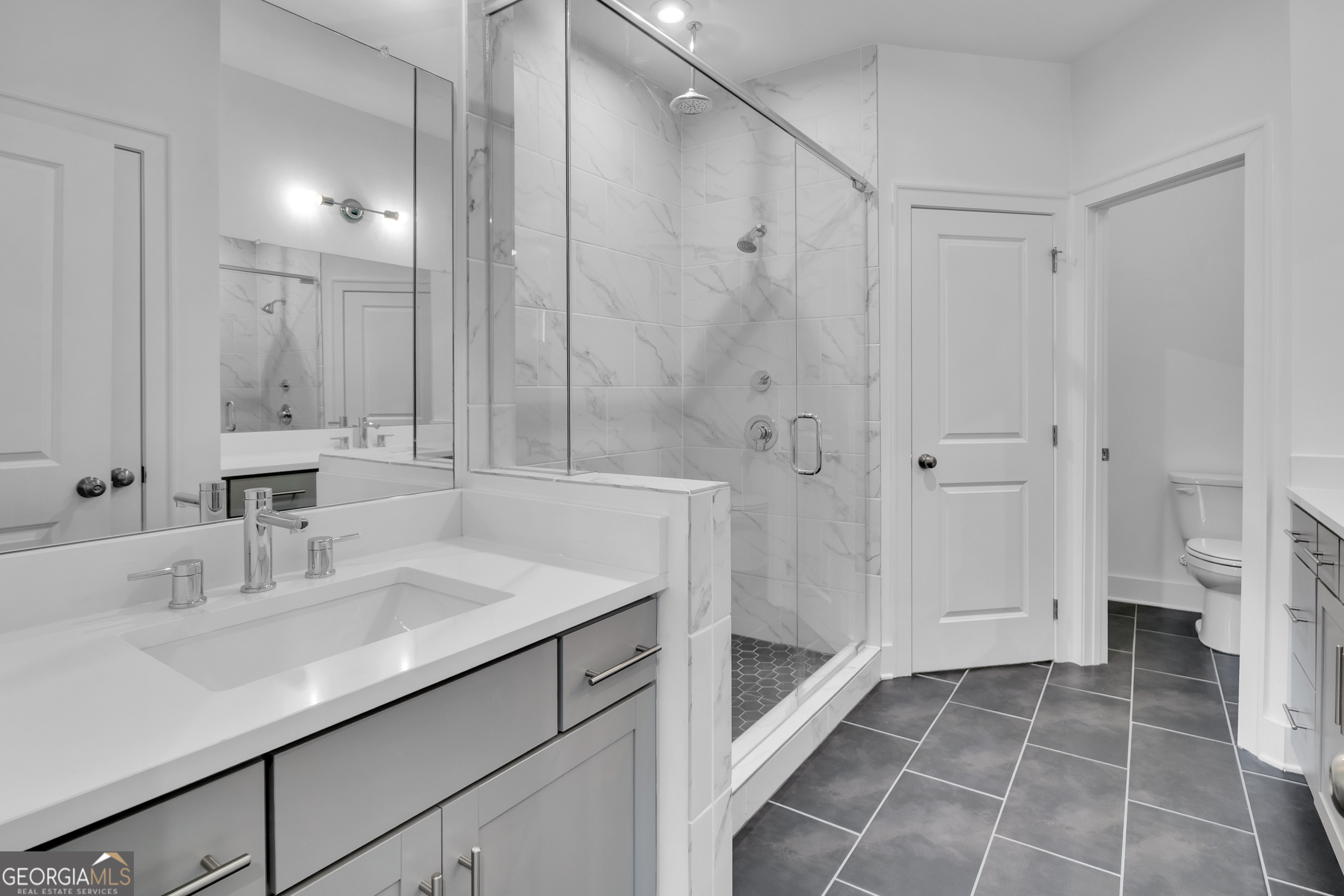 545 Whitlox Road Northwest Atlanta, GA 30309 - Photo 25 of 65 a bathroom with a sink shower and a toilet
