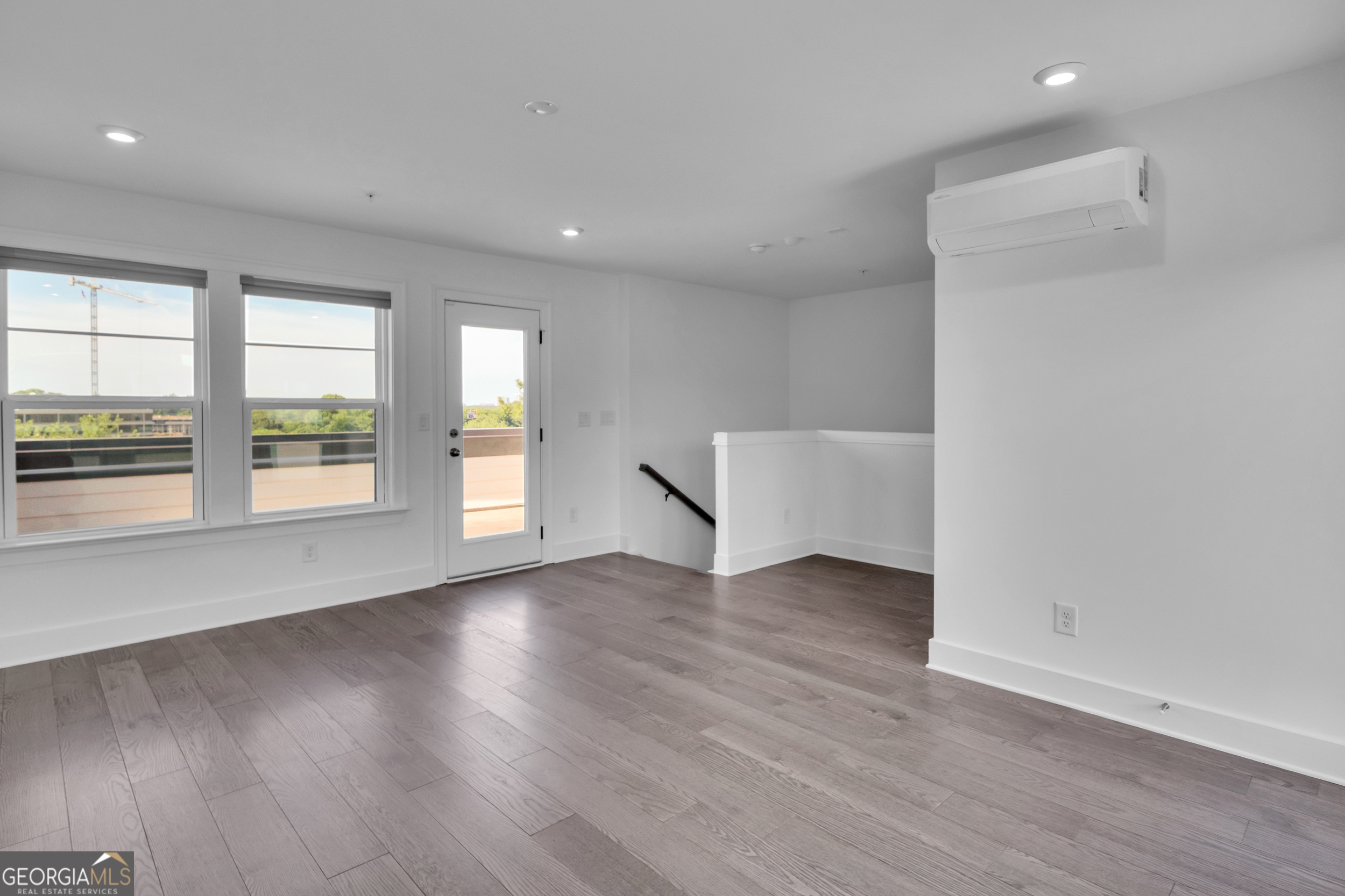 545 Whitlox Road Northwest Atlanta, GA 30309 - Photo 31 of 65 an empty room with wooden floor and windows