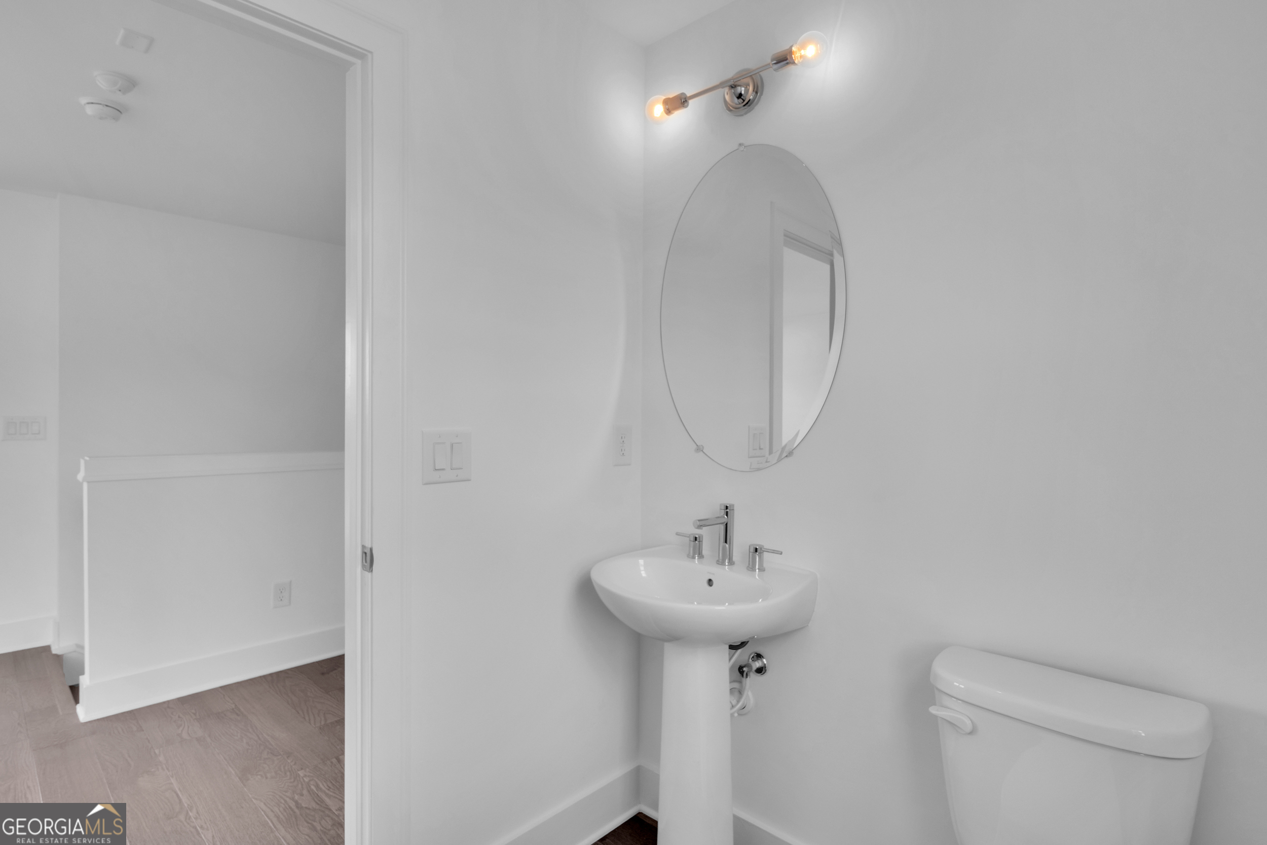 545 Whitlox Road Northwest Atlanta, GA 30309 - Photo 40 of 65 a bathroom with a sink toilet and a mirror