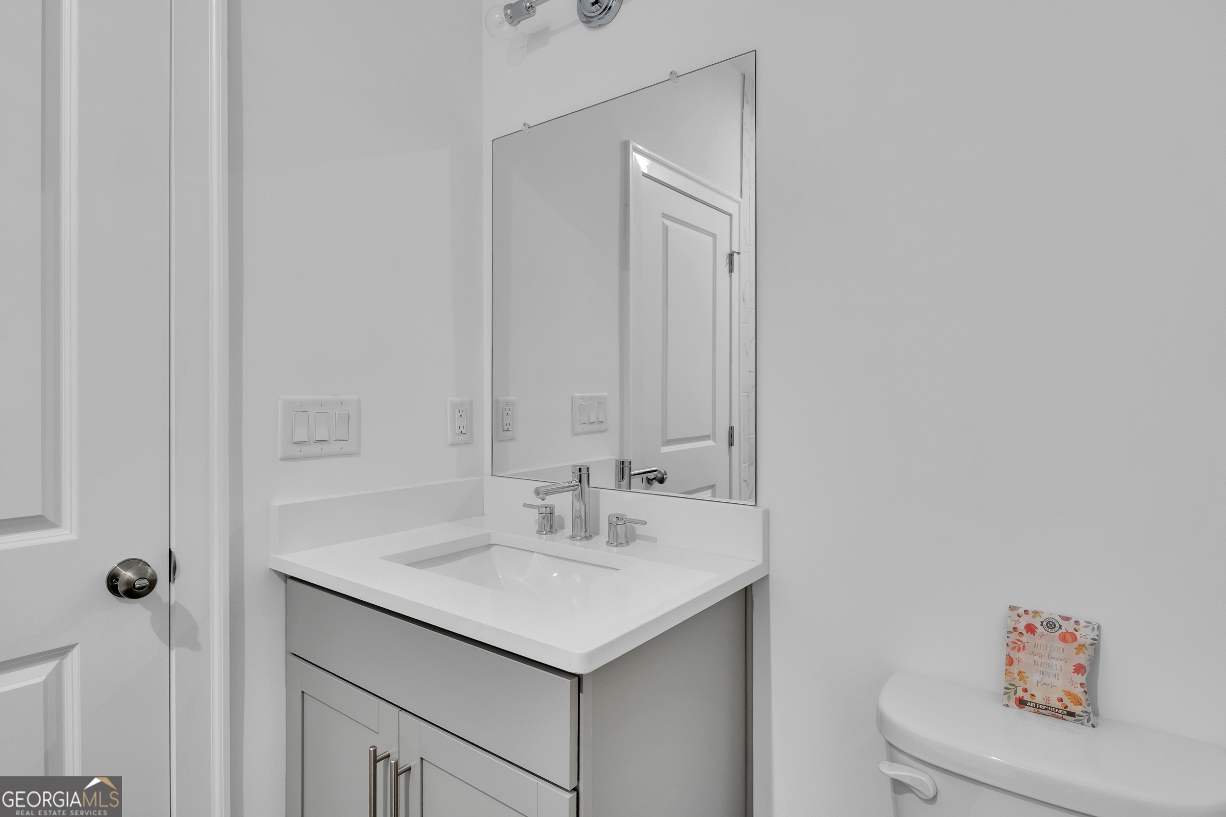 545 Whitlox Road Northwest Atlanta, GA 30309 - Photo 48 of 65 a bathroom with a sink and a mirror
