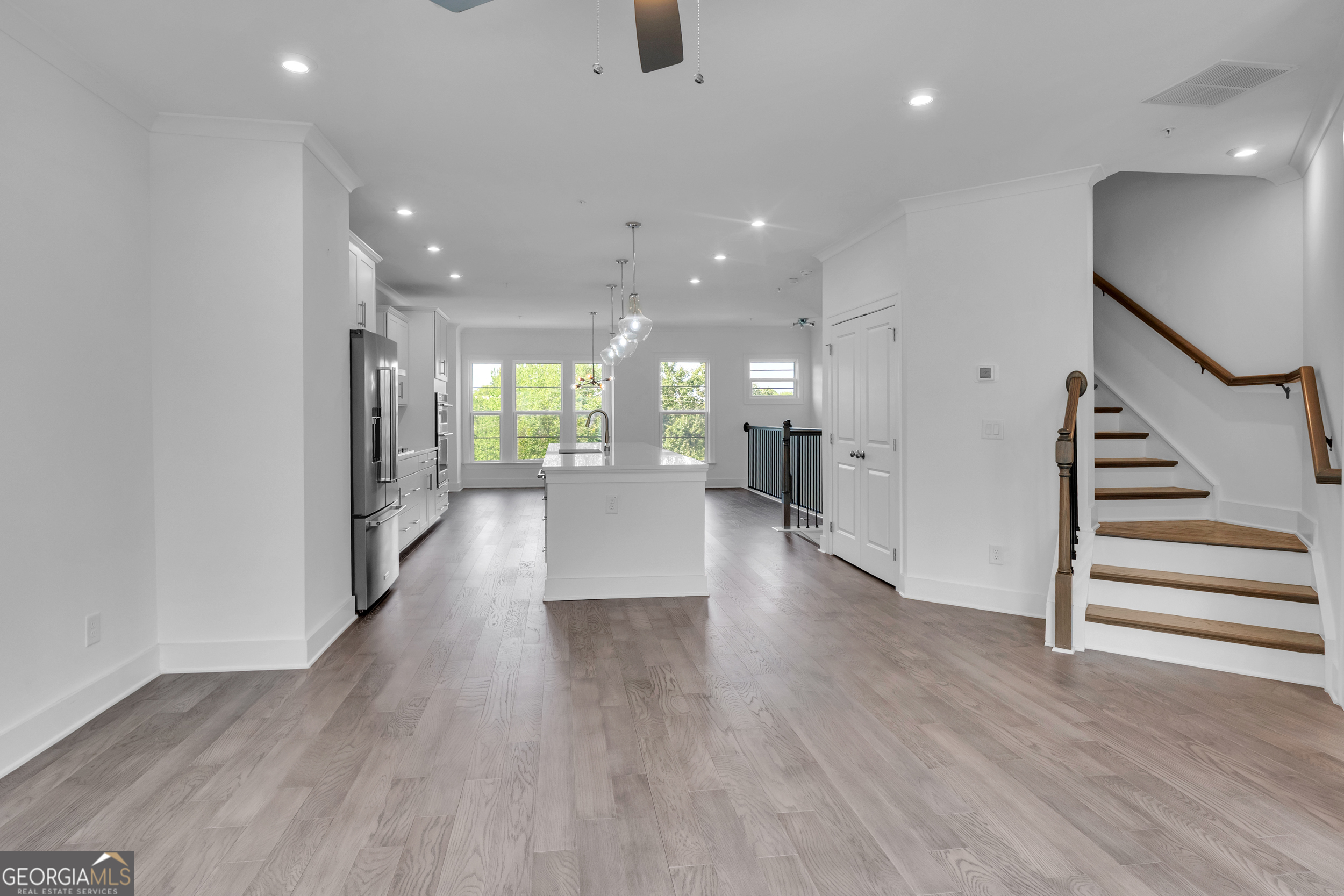 545 Whitlox Road Northwest Atlanta, GA 30309 - Photo 5 of 65 an empty room with wooden floor and windows