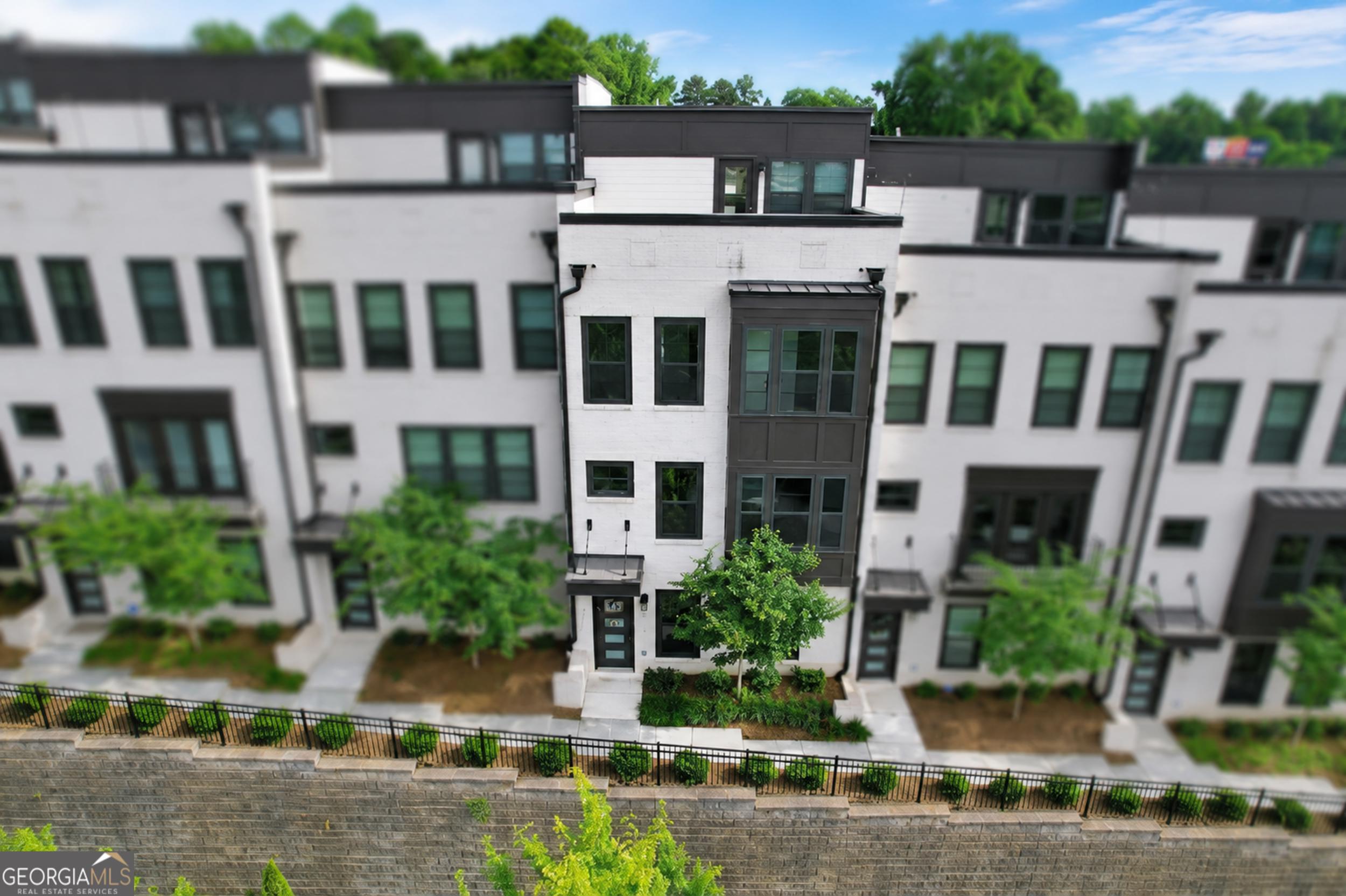 545 Whitlox Road Northwest Atlanta, GA 30309 - Photo 61 of 65 front view of a building with a garden
