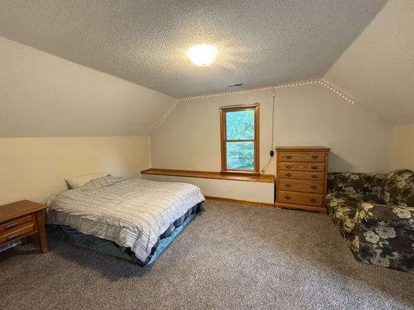 a spacious bedroom with a bed and a closet