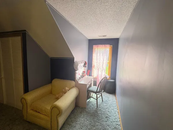 a spacious bedroom with a bed and a closet