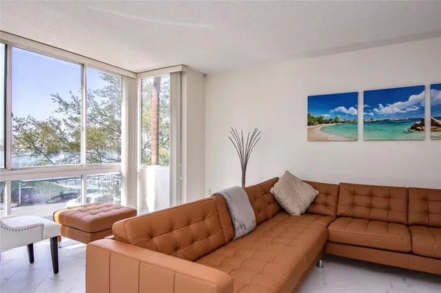 a large kitchen with kitchen island a large window cabinets and stainless steel appliances