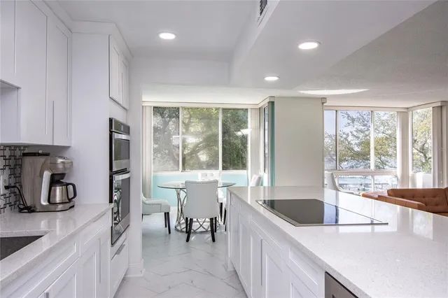 a kitchen with stainless steel appliances a sink stove and cabinets