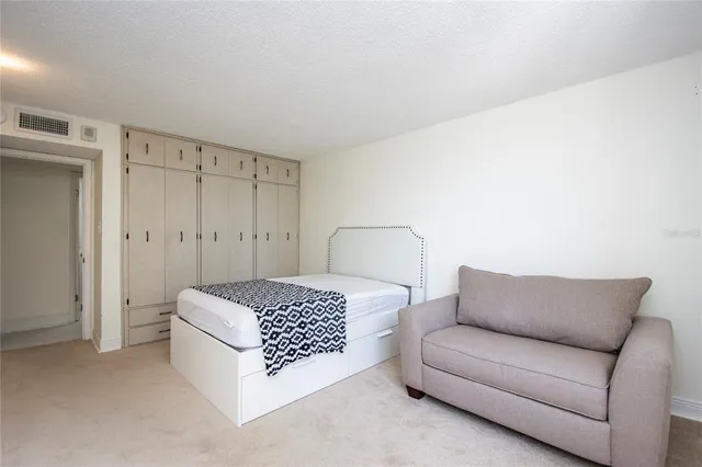 a bedroom with a bed and large window