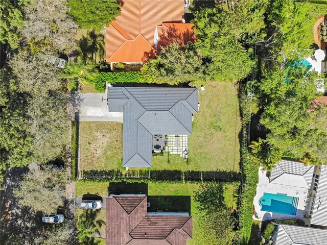 an aerial view of a house with a yard