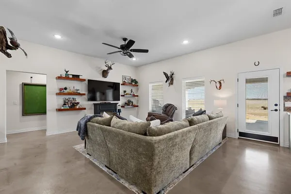 a living room with furniture and a wooden floor