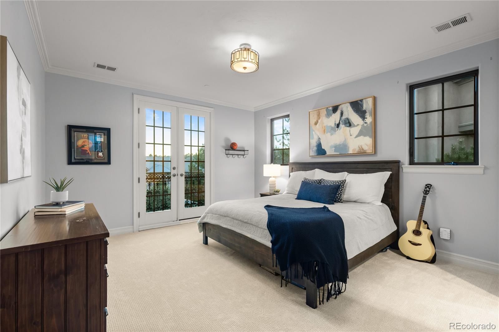 1033 Buffalo Ridge Road Castle Pines, CO 80108 - Photo 25 of 43 a spacious bedroom with a bed and a window