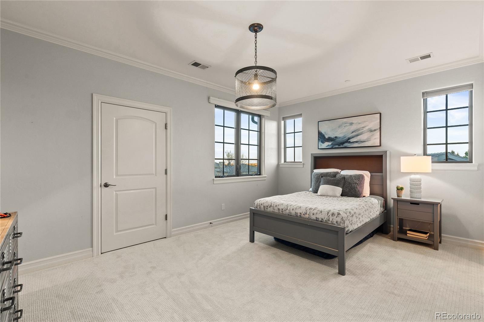 1033 Buffalo Ridge Road Castle Pines, CO 80108 - Photo 29 of 43 a bedroom with a bed window and a table in it