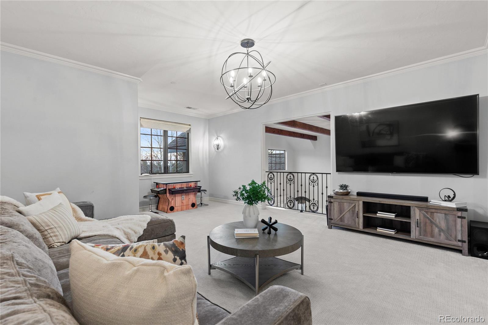 1033 Buffalo Ridge Road Castle Pines, CO 80108 - Photo 30 of 43 a living room with furniture and a flat screen tv