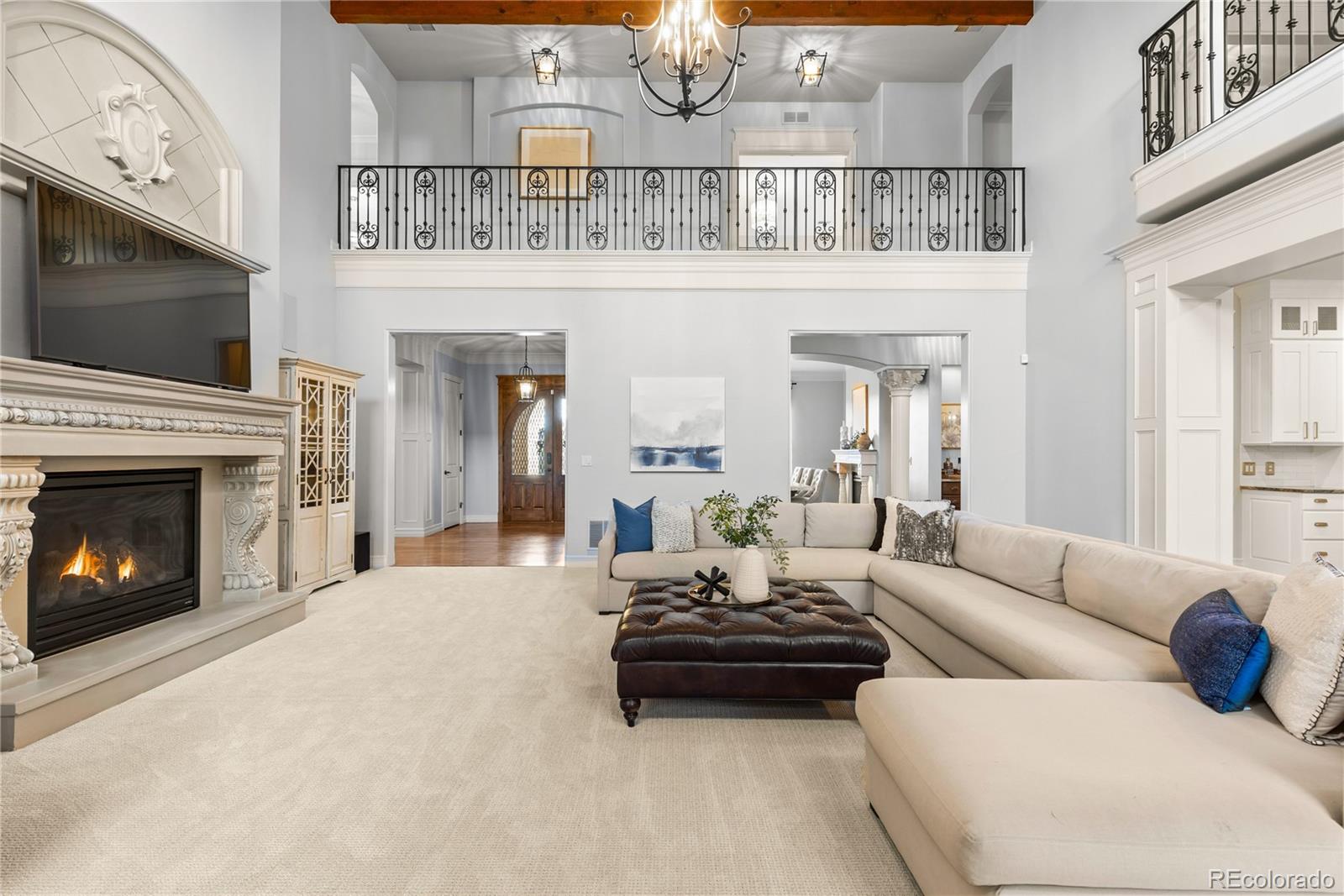 1033 Buffalo Ridge Road Castle Pines, CO 80108 - Photo 5 of 43 a living room with furniture a flat screen tv and a fireplace