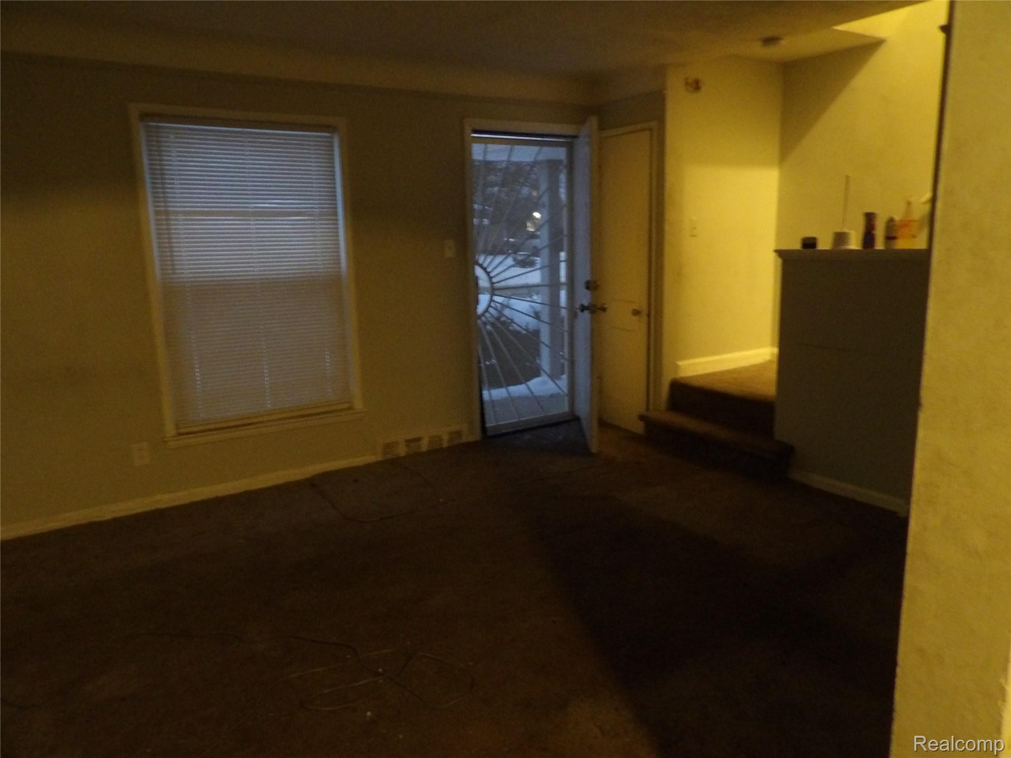 19985 Meyers Road Detroit, MI 48235 - Photo 5 of 16 Spare room featuring dark carpet and baseboards