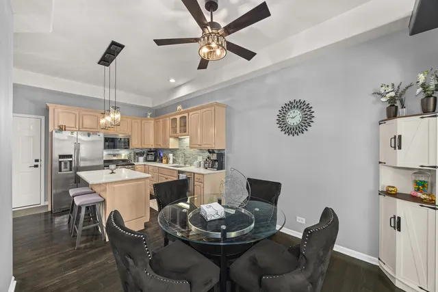 a kitchen with a dining table and chairs