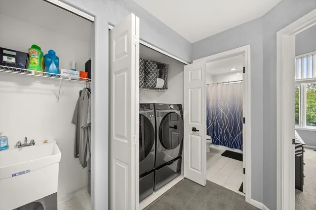 a utility room with sink dryer and washer