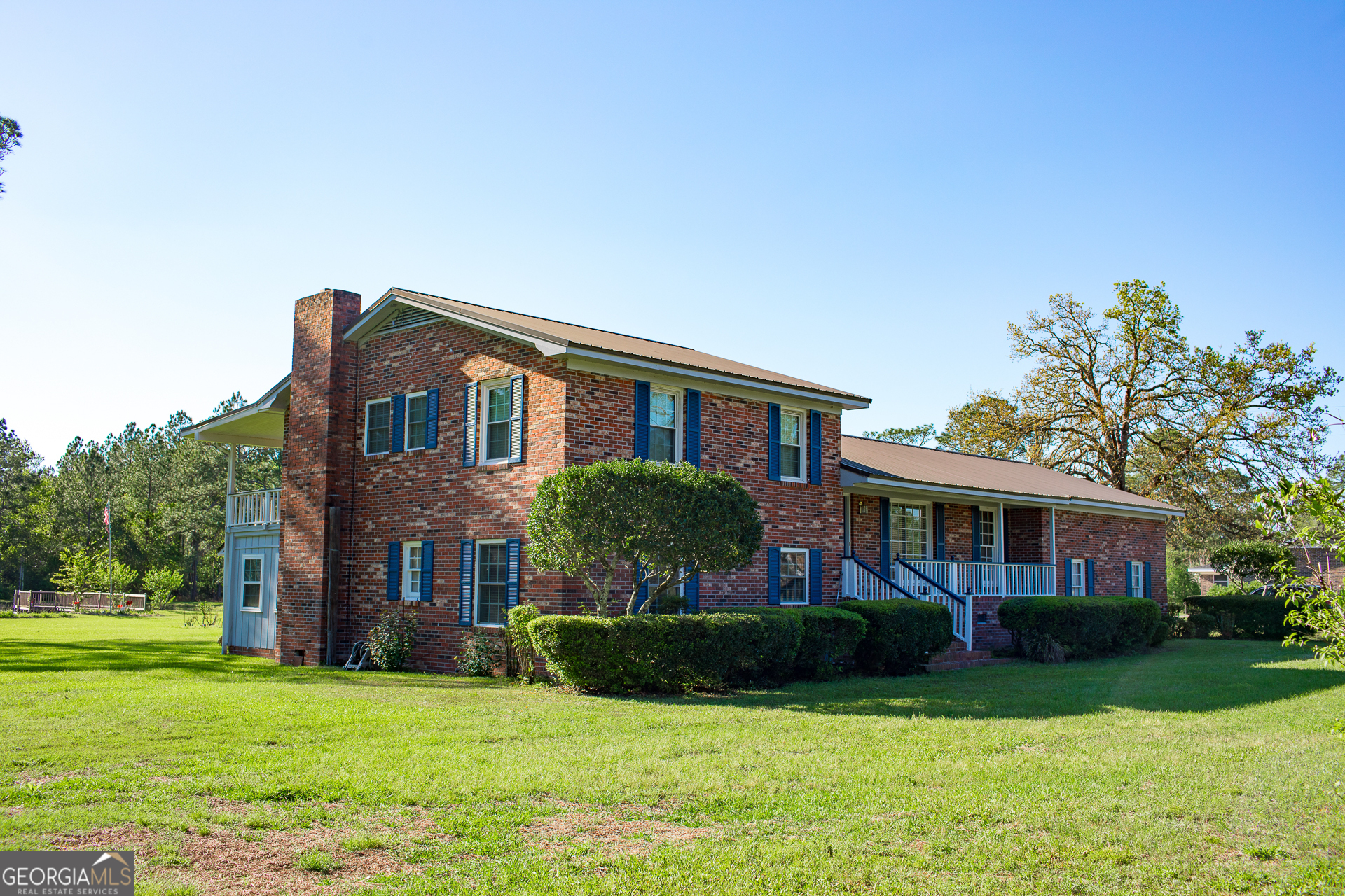 2110 Ware Street Blackshear, GA 31516 - Photo 4 of 57 a front view of a house with a garden and yard
