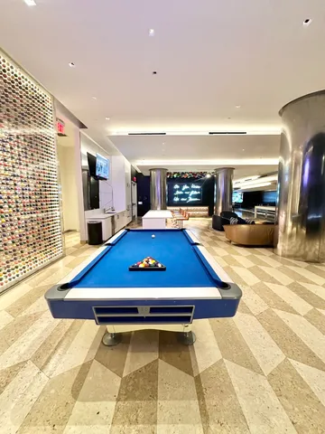 a room with pool table and flat screen tv