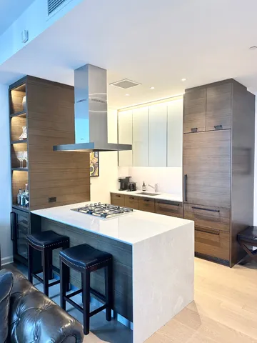 a kitchen with a sink a stove a table and chairs