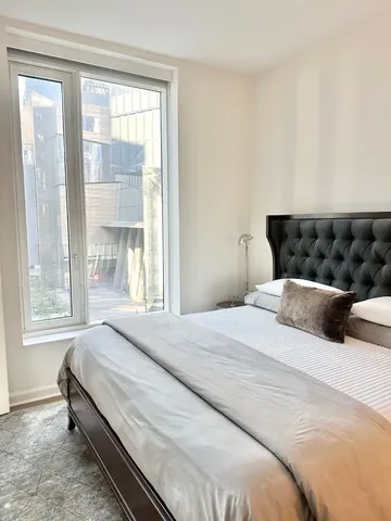 a bedroom with a bed and window