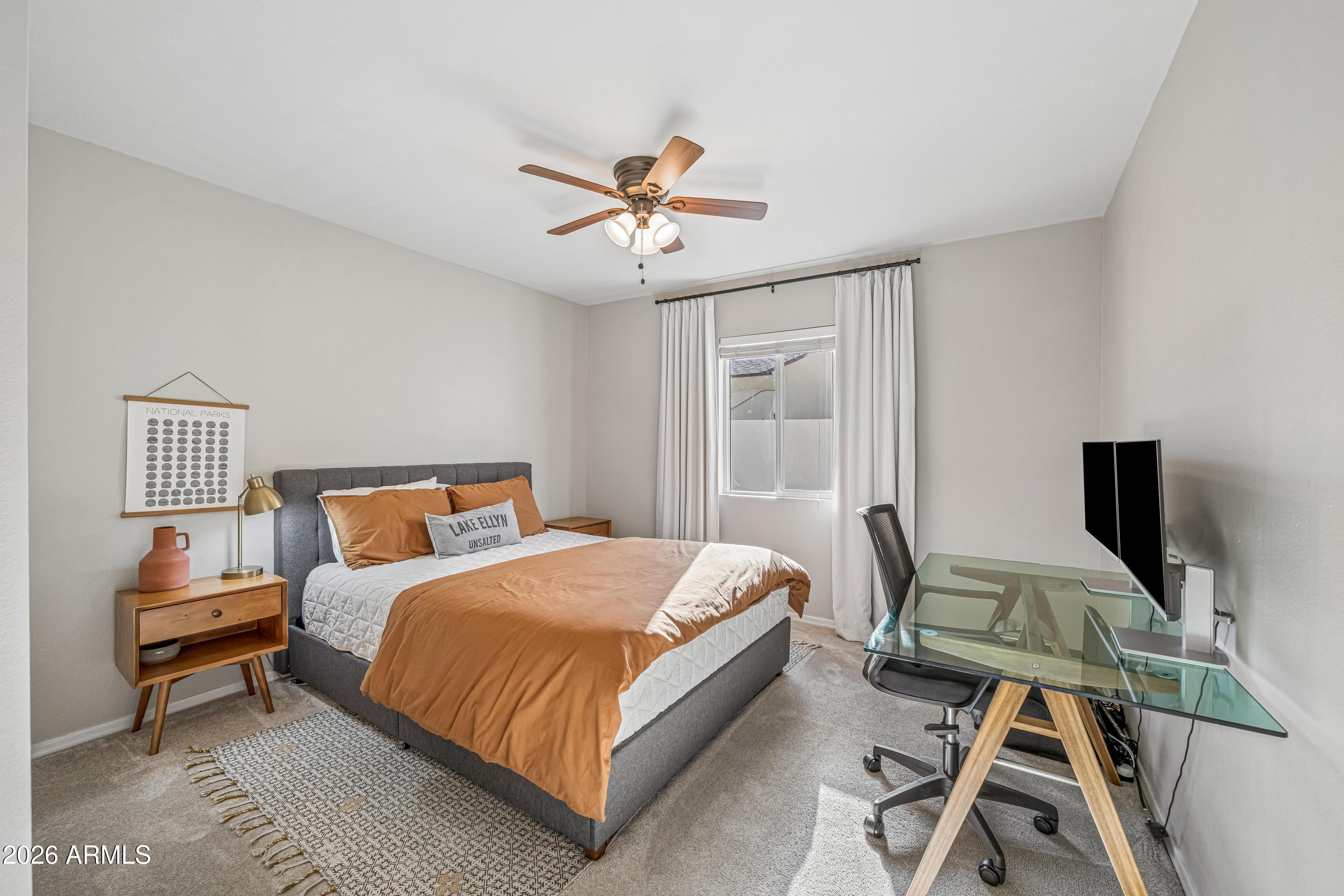 2327 East Weldon Avenue Phoenix, AZ 85016 - Photo 13 of 34 a bedroom with a bed and a chandelier
