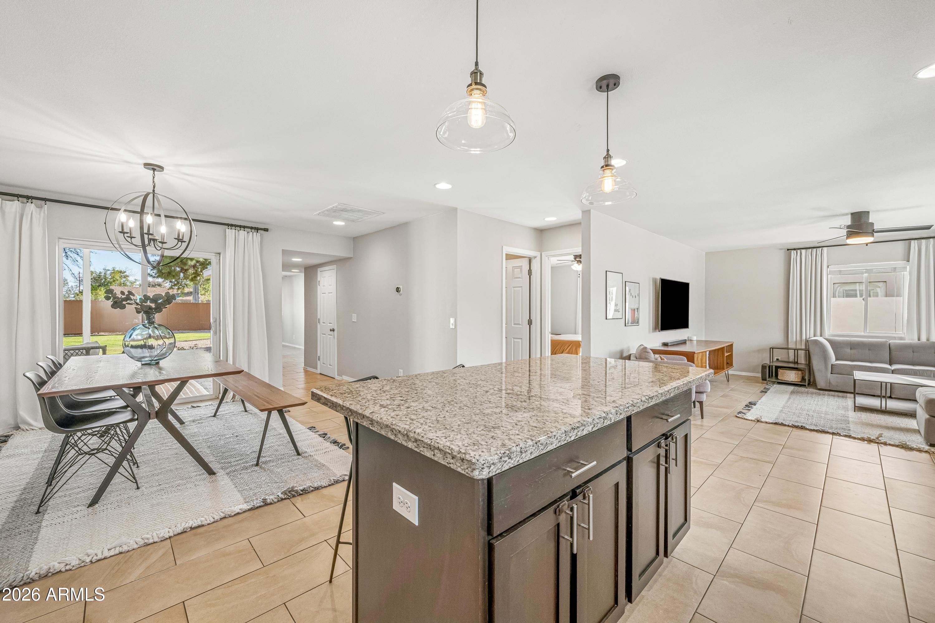 2327 East Weldon Avenue Phoenix, AZ 85016 - Photo 8 of 34 a kitchen with a table chairs and living room view
