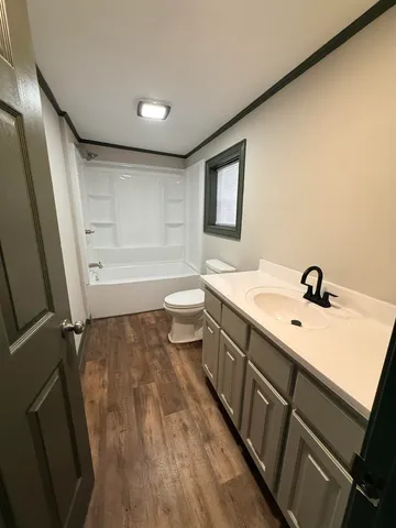 a bathroom with a sink a toilet a mirror and vanity