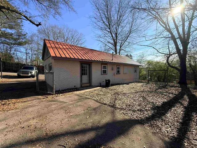 a house with trees in the background
