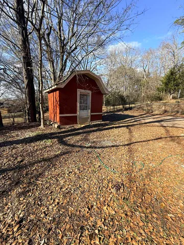 a dirt road with a building in the background